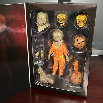 Set of Halloween-themed action figures in a display case on a wooden surface.