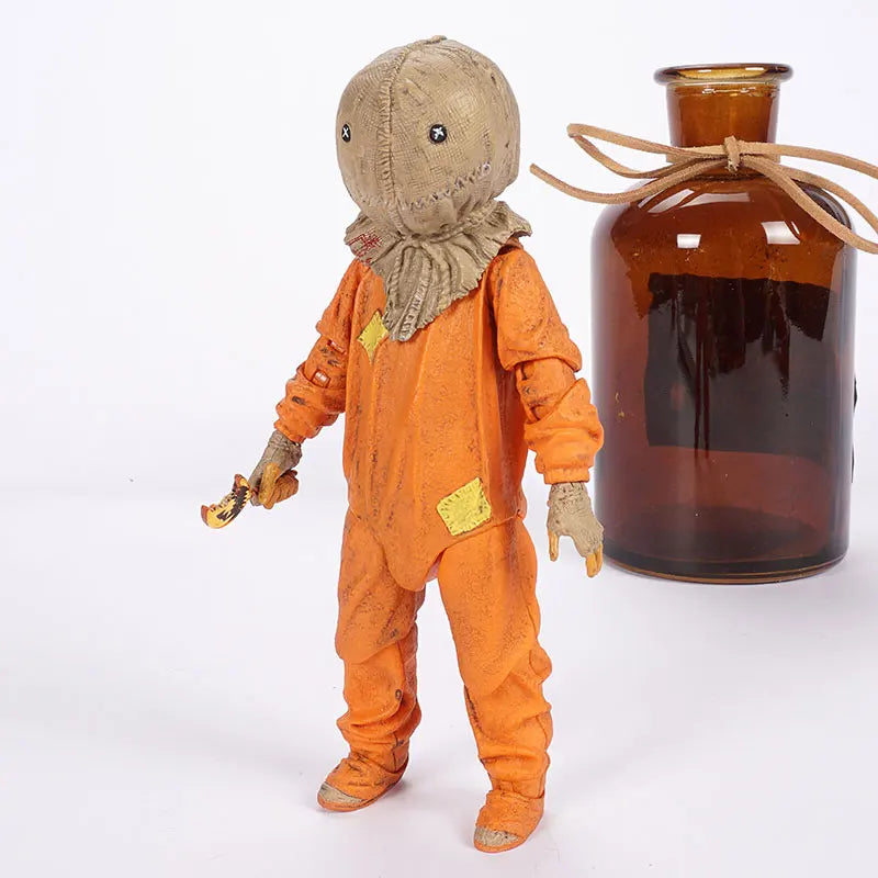 Toy figure in an orange jumpsuit with a brown bottle on a white background