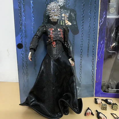 Action figure in a black outfit with intricate details, standing against a blue chain-link background.