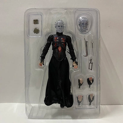 Action figure in clear packaging with accessories on a white background