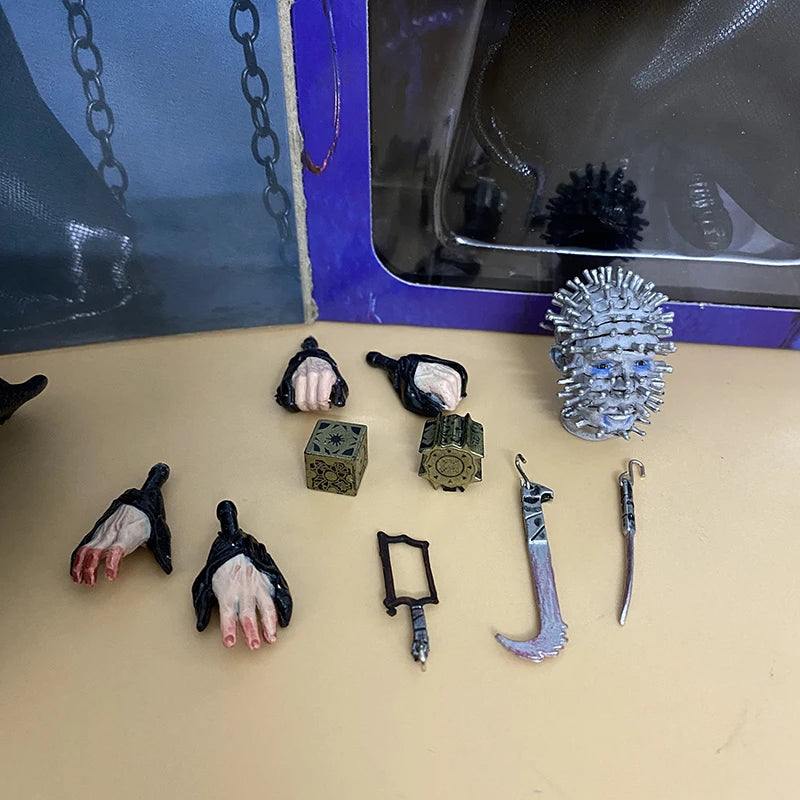Collection of horror-themed props including hands, tools, and a spiked ball on a beige surface.