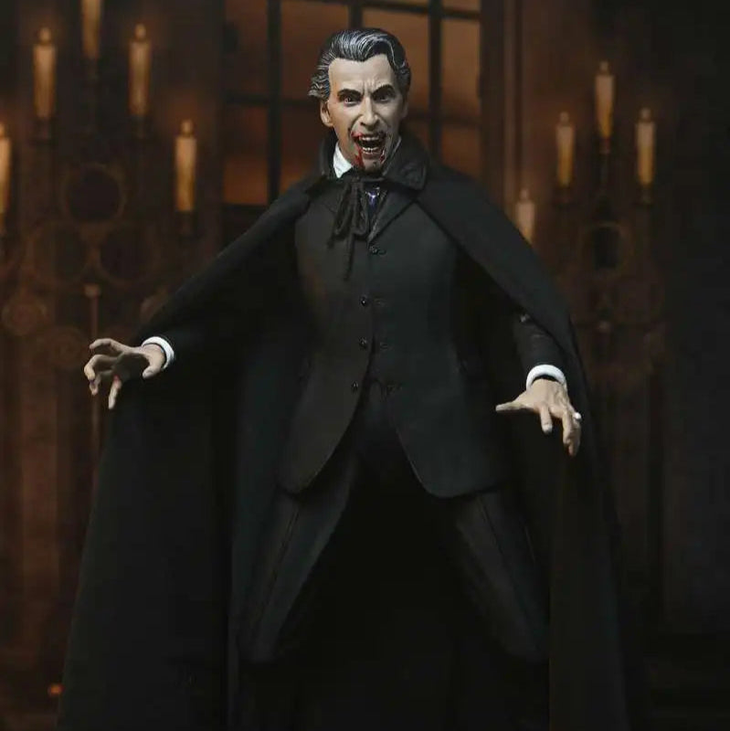 Action figure of a character in a dark suit with a cape against a candlelit background