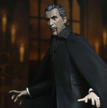 Action figure of a character in a dark suit with a cape against a blurred background