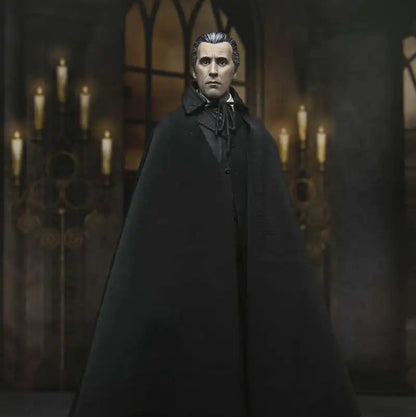 Man in a dark cloak standing in a dimly lit room with candles.