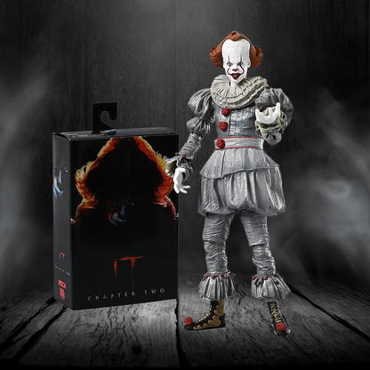 Action figure of a character from 'IT' next to its packaging on a dark background
