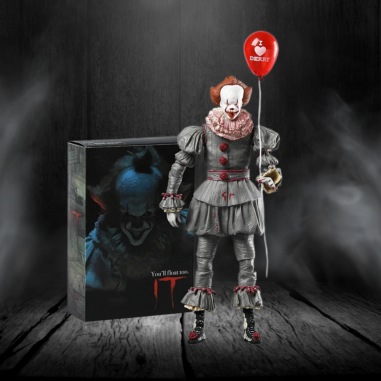 Action figure of a clown with a red balloon and packaging in the background