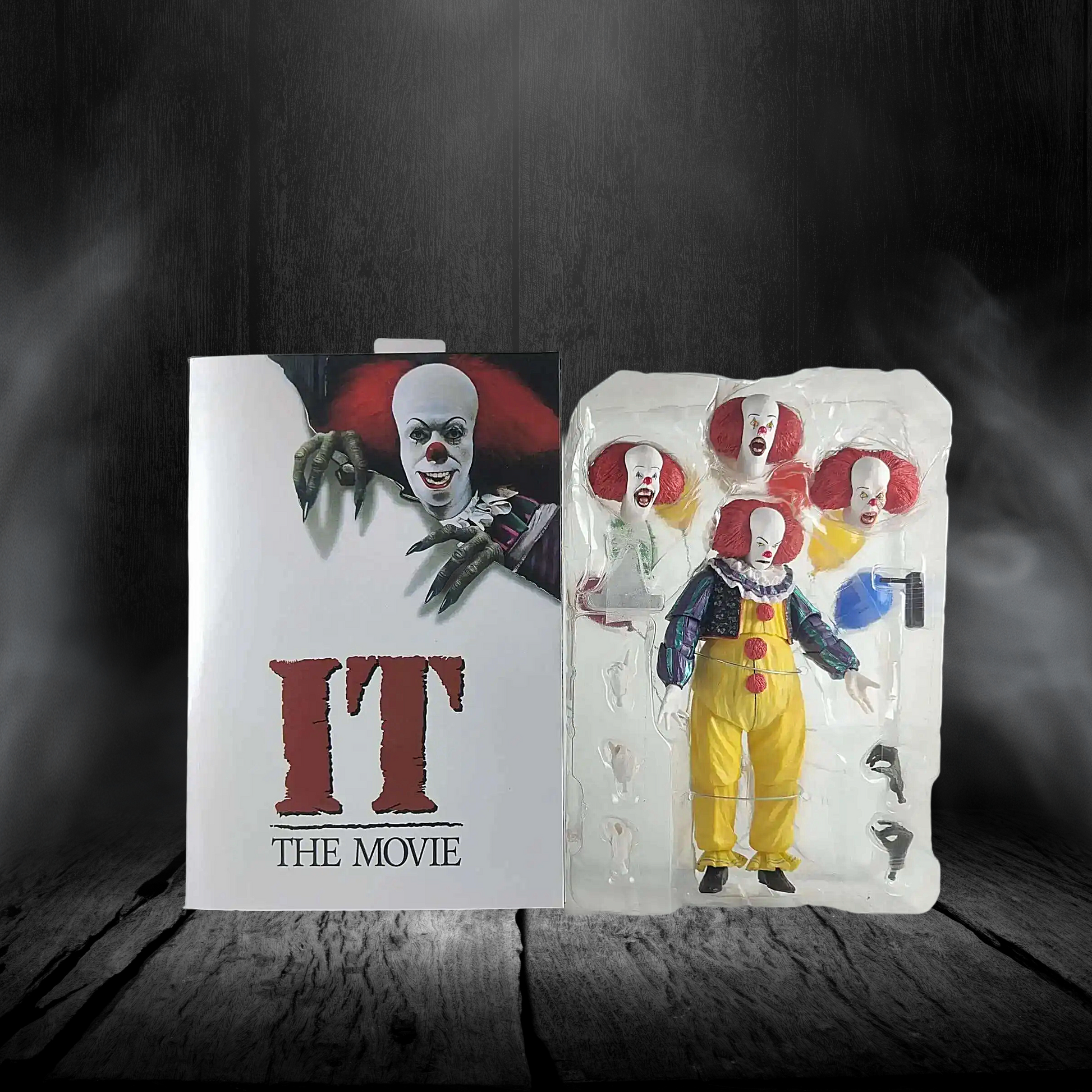 Action figure packaging of a clown from 'IT' with movie poster in the background
