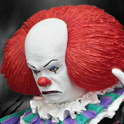 Close-up of a clown figure with red hair and white face against a dark background