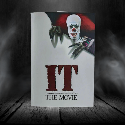 Notebook with a clown design and 'IT: The Movie' text on a dark background