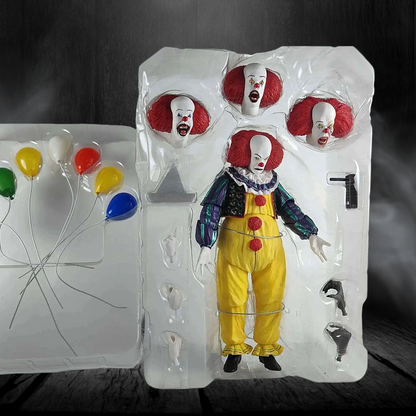 Action figure of a clown in packaging with balloons on a dark background