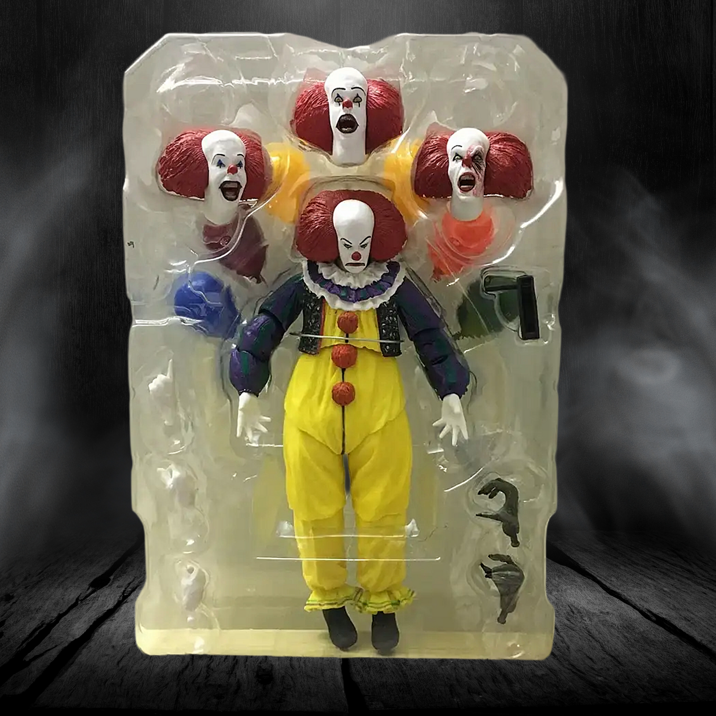 Action figure of a clown in a clear packaging on a dark background
