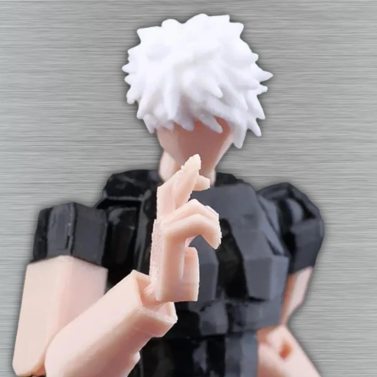 Close-up of a hand holding a small figurine with white hair and black clothing against a neutral background