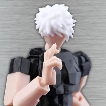 Close-up of a hand holding a small figurine with white hair and black clothing against a neutral background