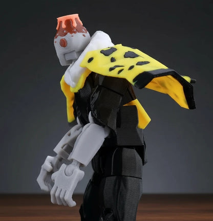 Toy figure with a yellow cape and red helmet on a textured gray background