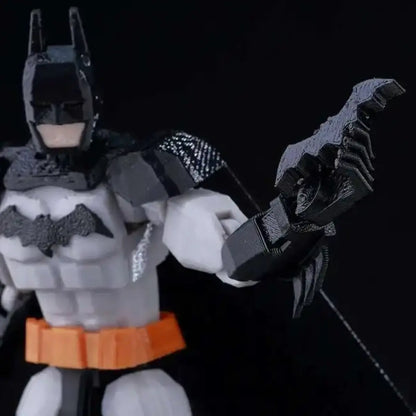 Batman action figure with a large weapon on a black background