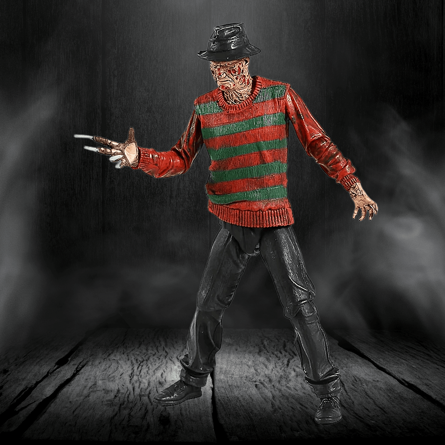Action figure in a red and green striped sweater with a dark background