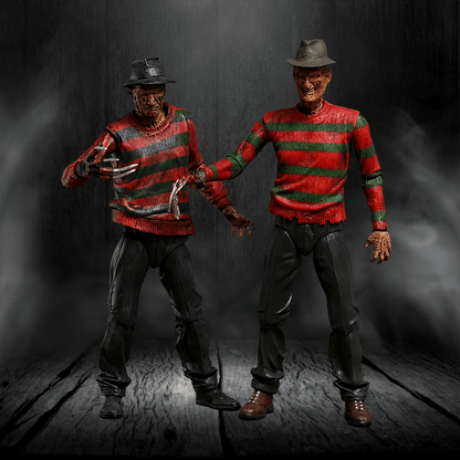 Two action figures of a character in a red and green striped sweater against a dark background.