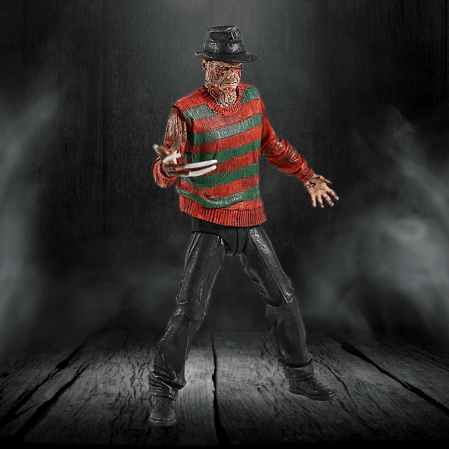 Action figure in a red and green striped sweater with a dark background