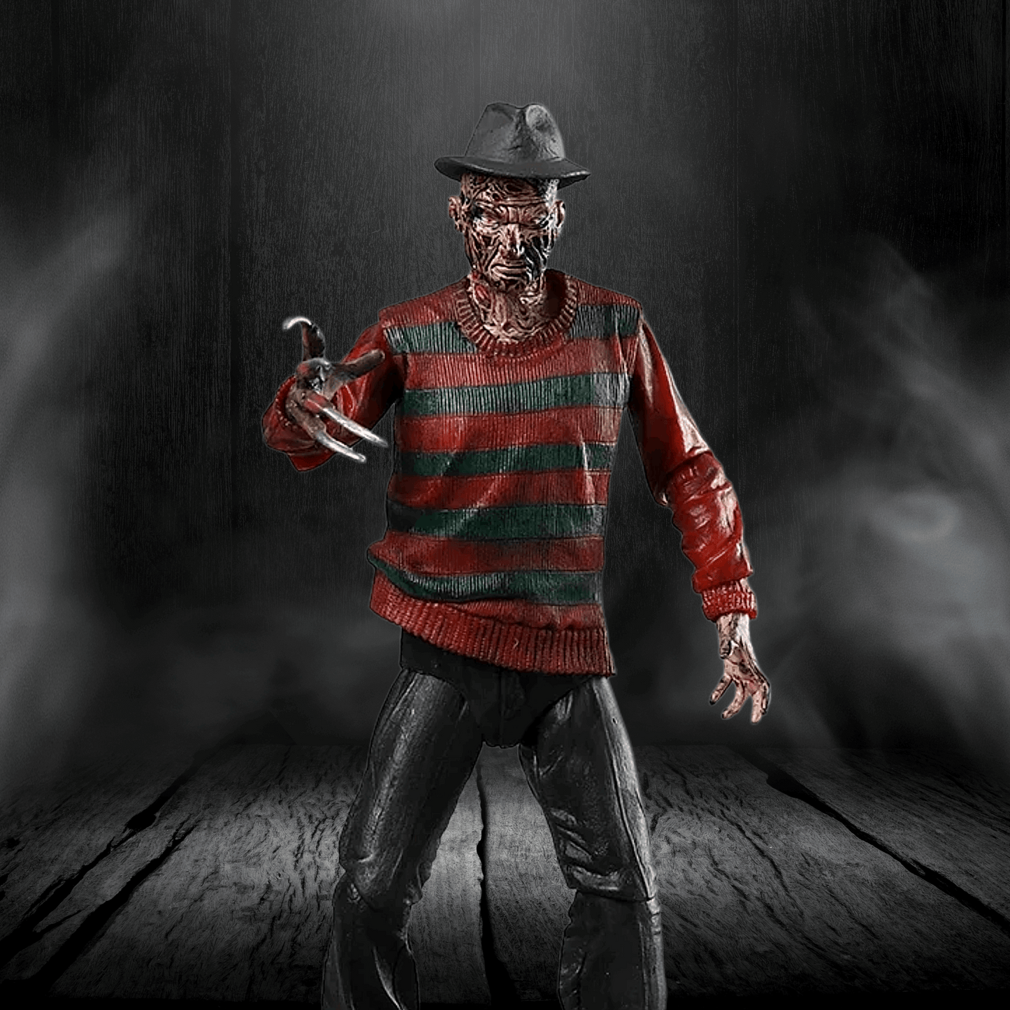Action figure in a red and green striped sweater with a dark background