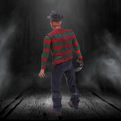 Action figure in a red and green striped sweater with a dark background