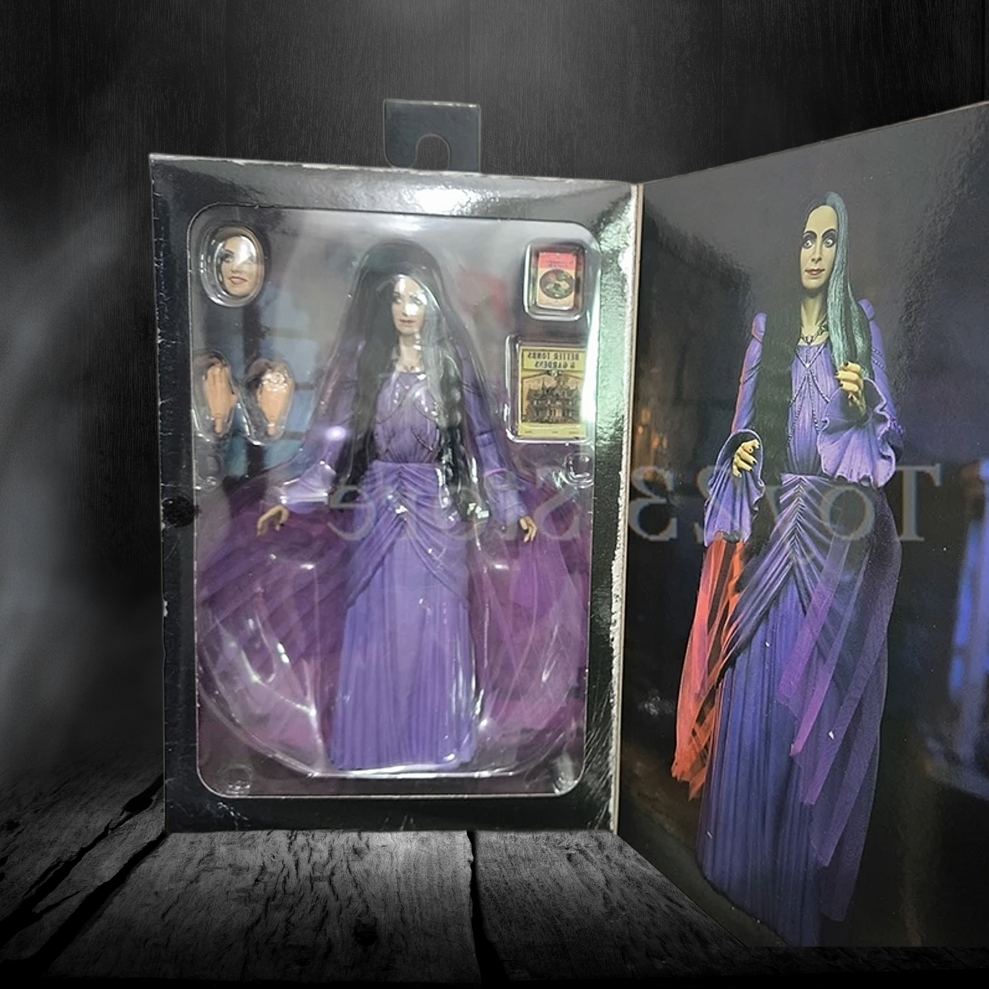 Action figure in a purple dress with packaging on a dark background