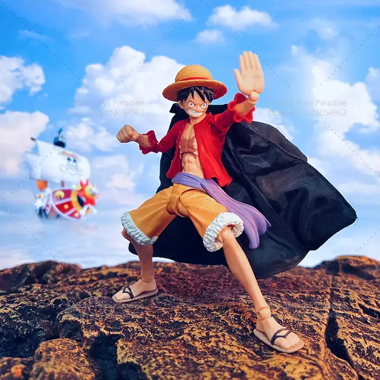 Action figure of a character from a popular anime series on a rocky outcrop with a blue sky and clouds in the background.