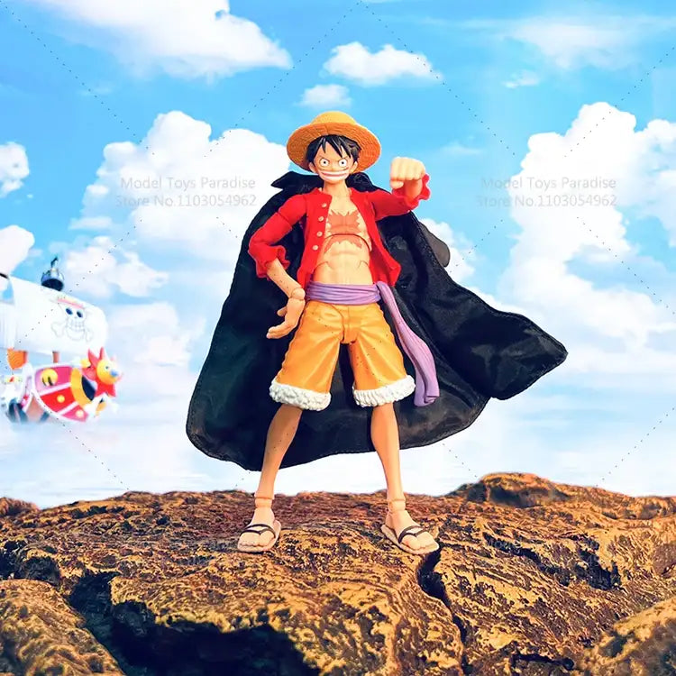 Action figure of a character from a popular anime series standing on a rocky outcrop with a blue sky in the background.