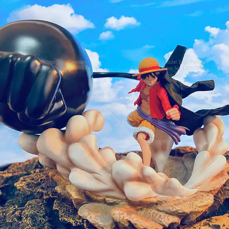 Figurine of a character from a popular anime series with a large black fist in the foreground against a blue sky.