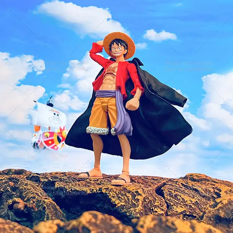 Action figure of a character from an anime standing on a rocky outcrop with a blue sky and clouds in the background.