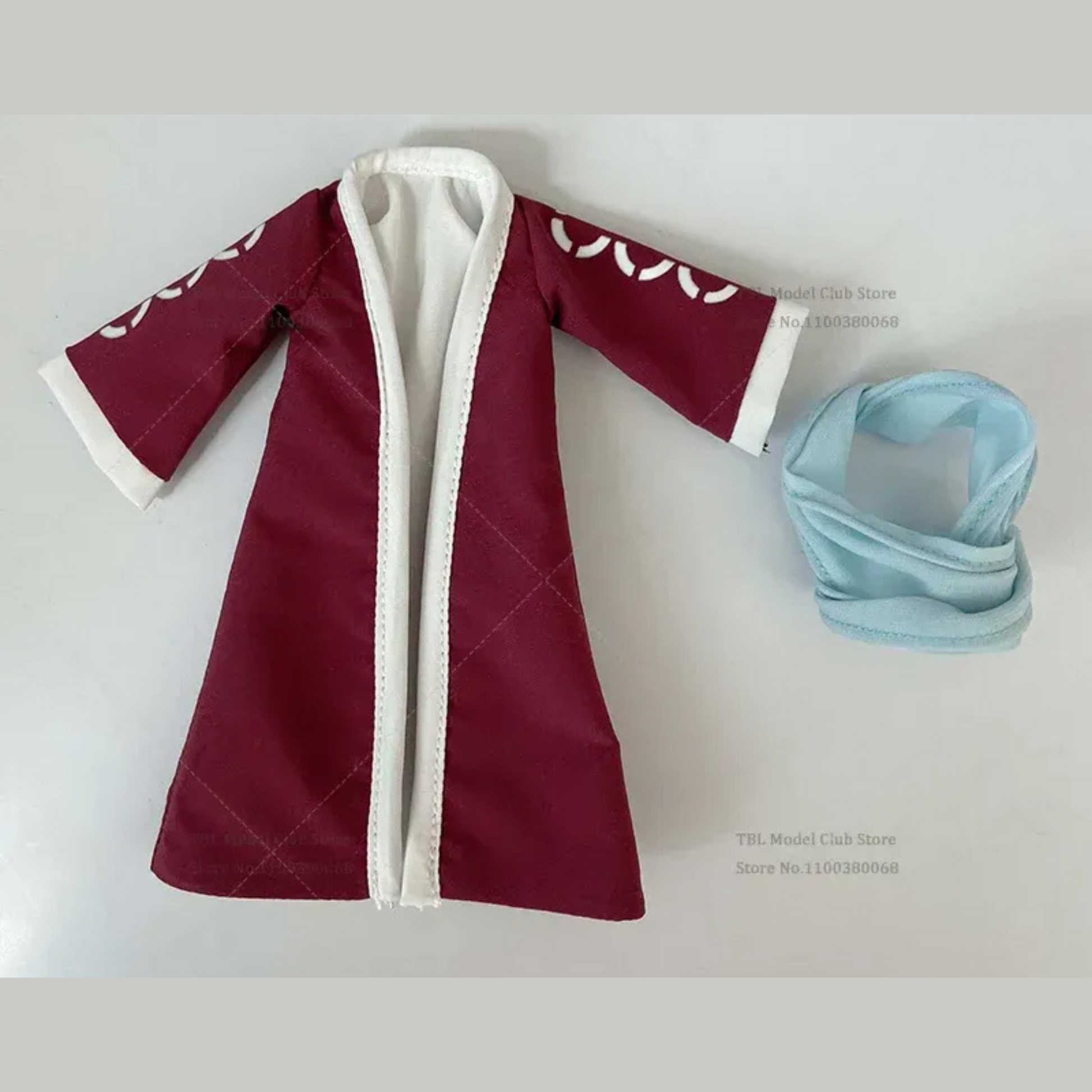 Red robe with white trim and a blue headband on a light gray background
