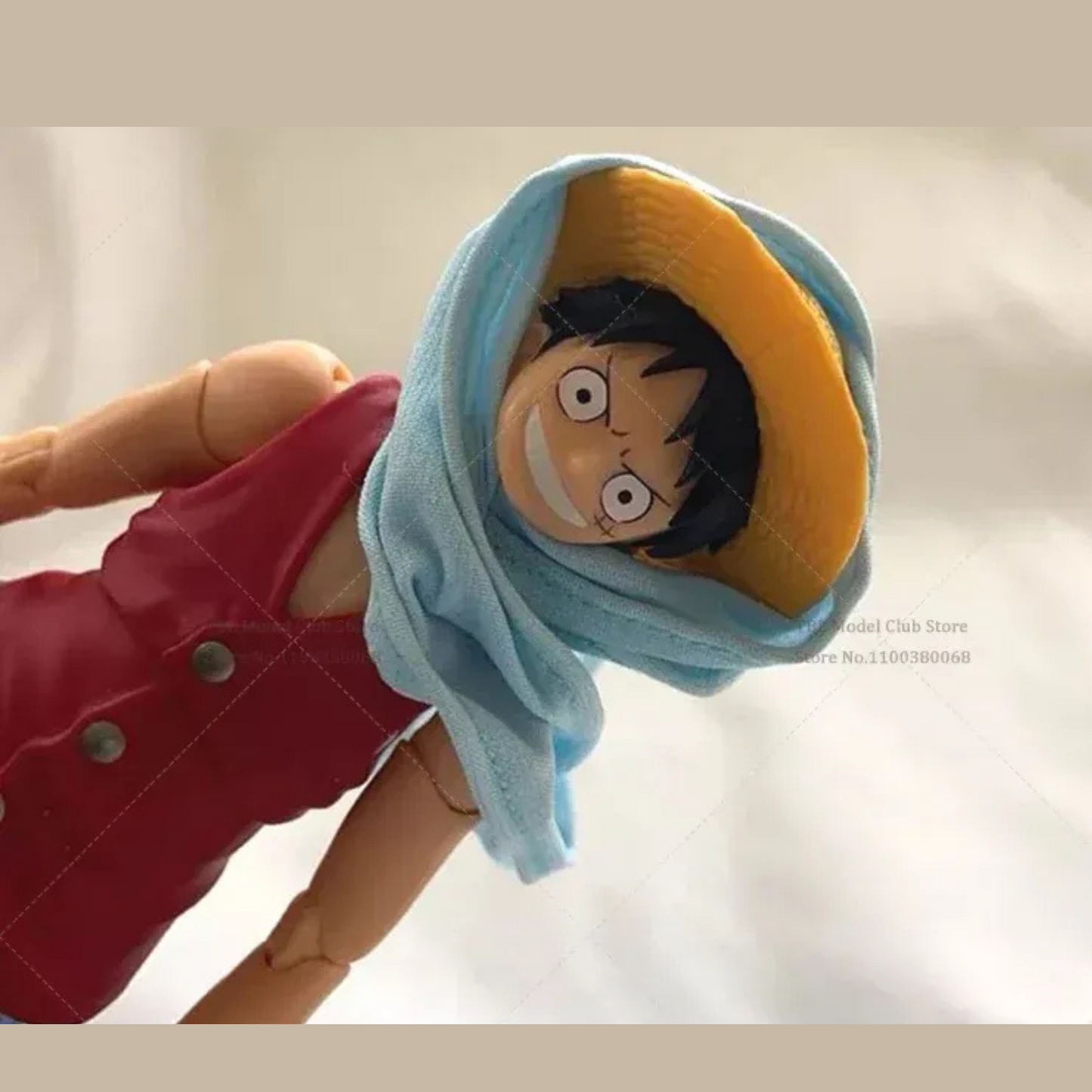 Toy figure with a character wearing a blue scarf on a plain background