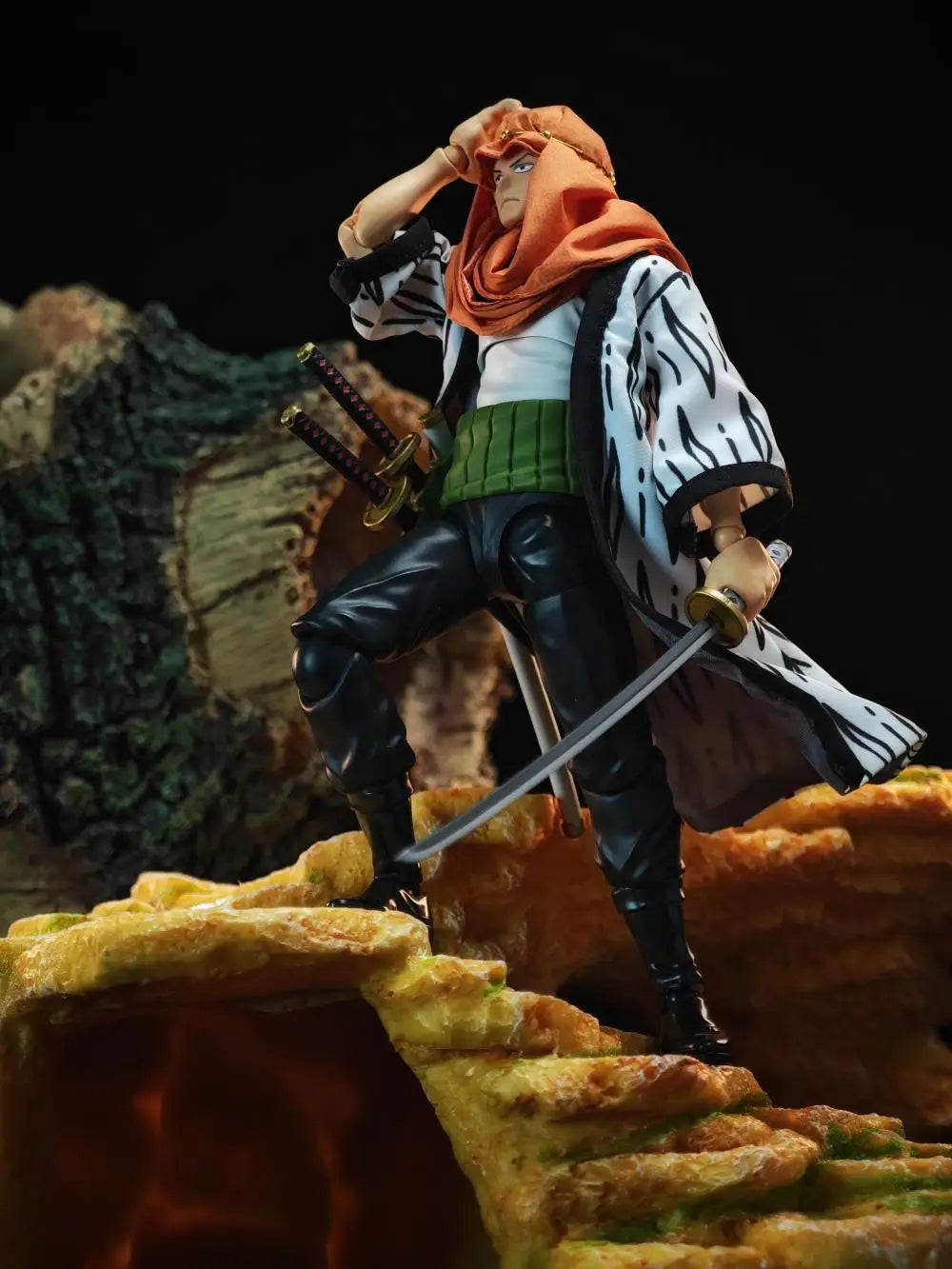 Action figure of a character with a sword on a rocky surface