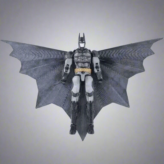 Batman action figure with large wings on a white background