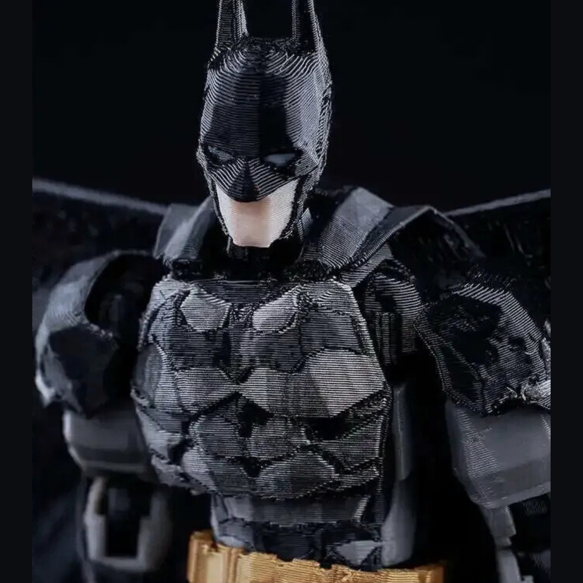 Batman action figure with detailed costume on a black background