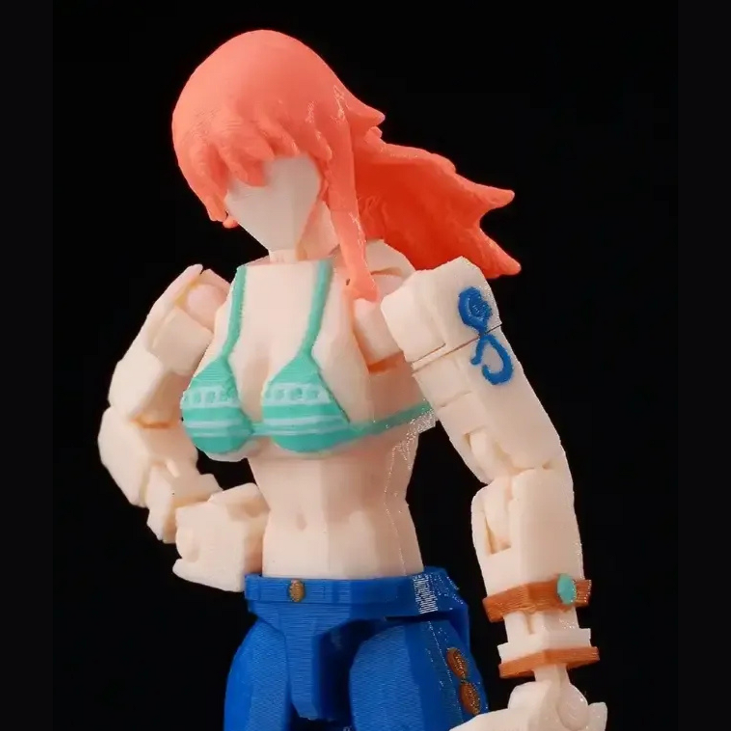 Toy figure with red hair and blue pants on a black background