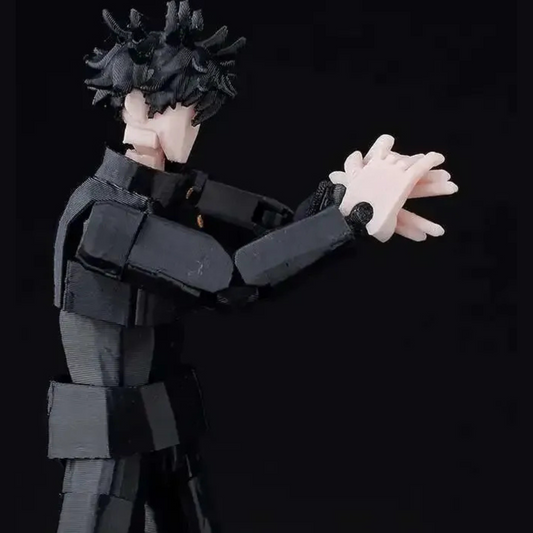Action figure with black hair and pink hands against a black background