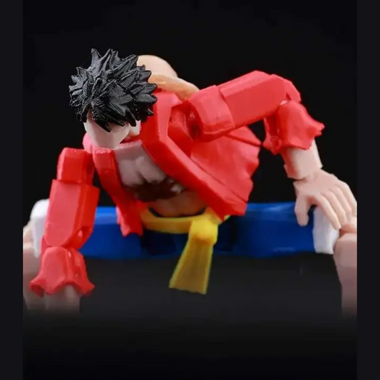 Action figure with red outfit and black hair on a black background