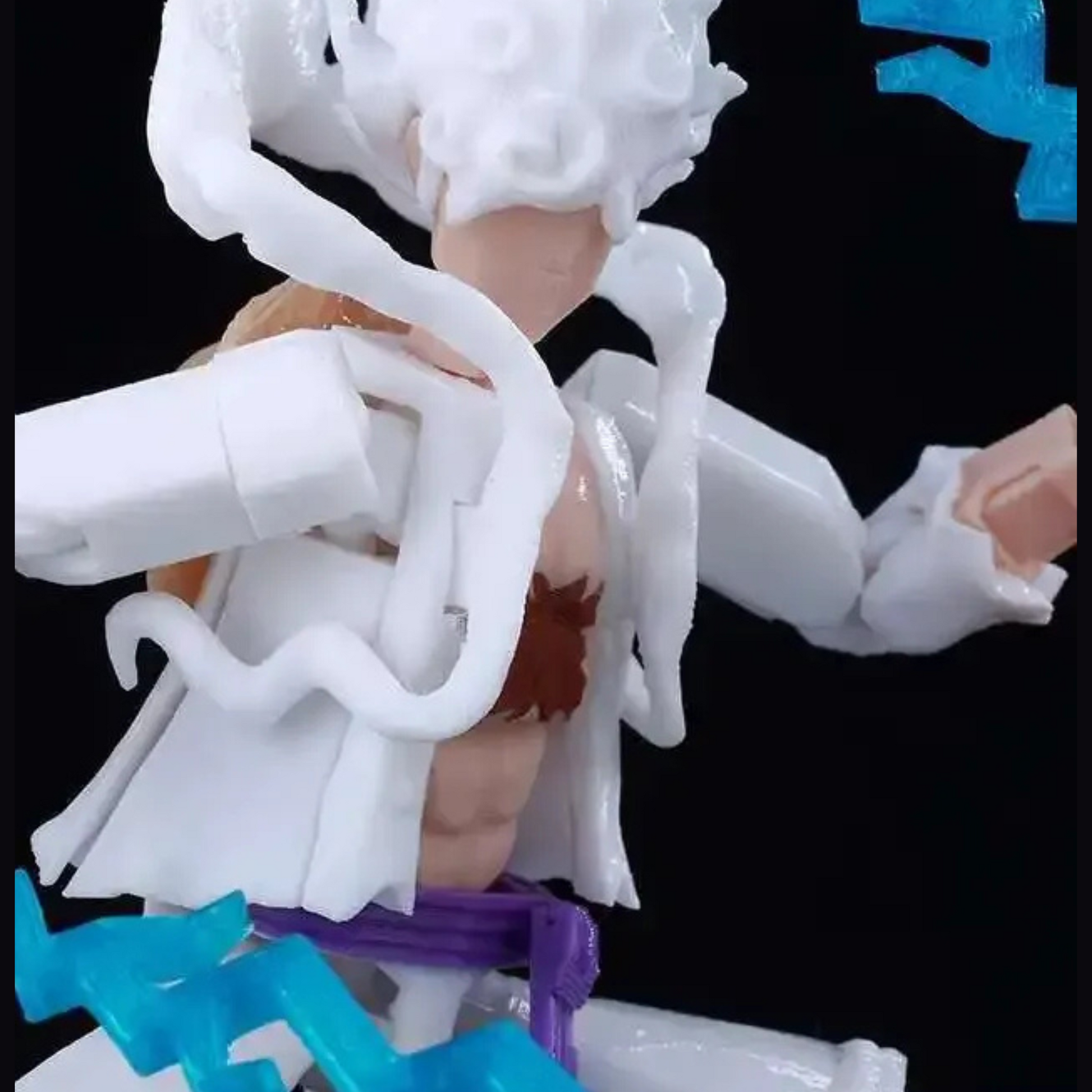 Toy figure with white hair and red outfit on a black background