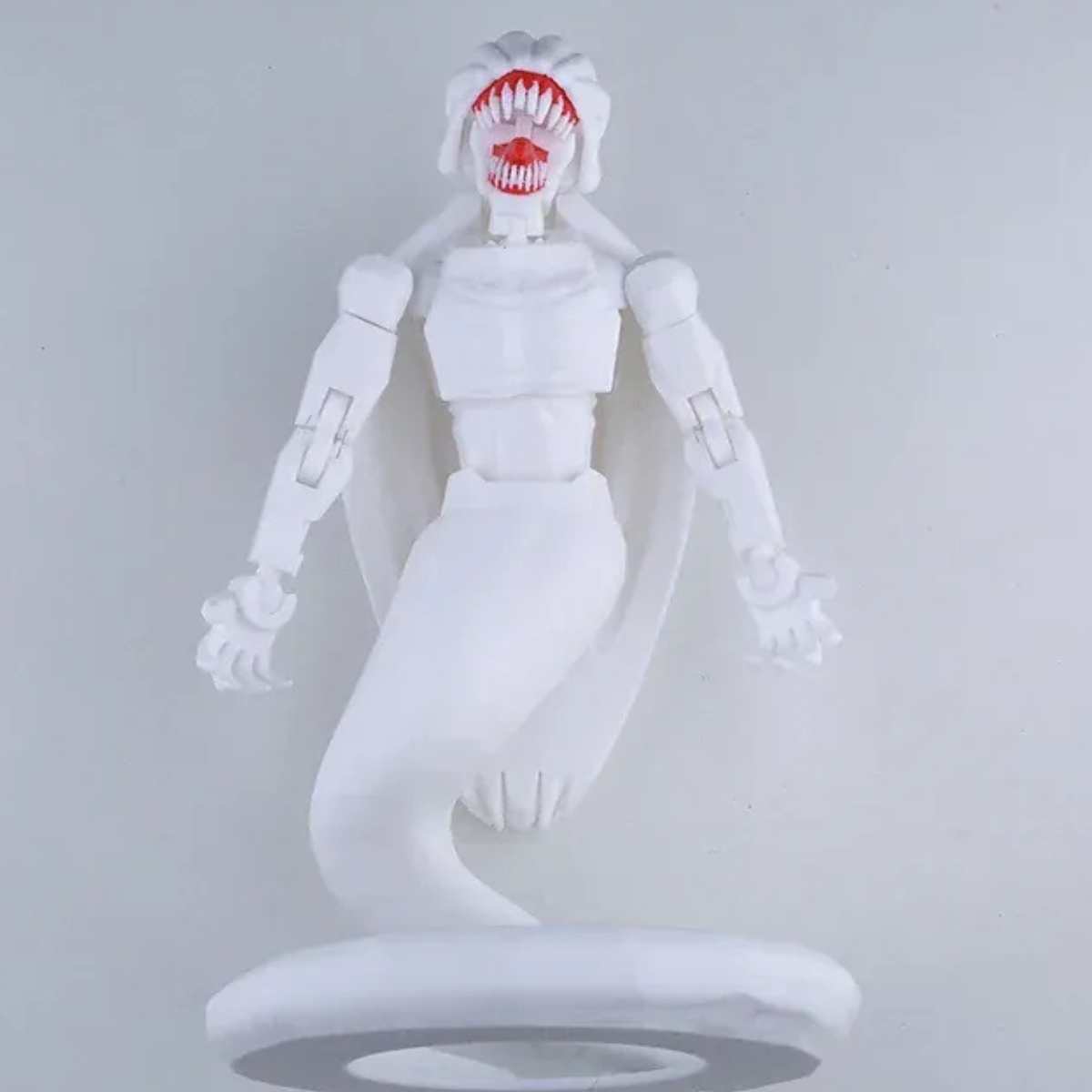 White robot-like figure with red mouth on a gray background