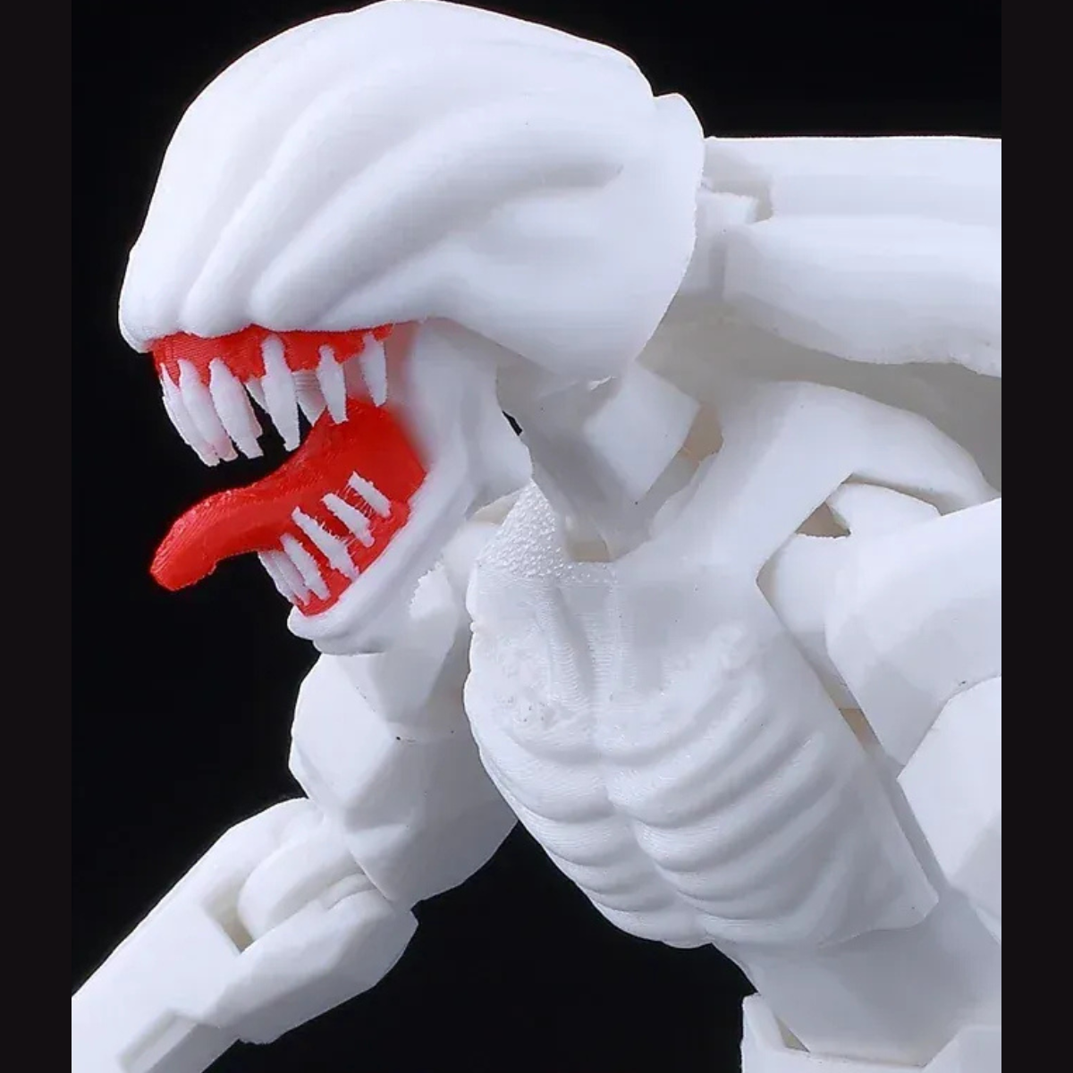 White and red creature figure with open mouth on a black background
