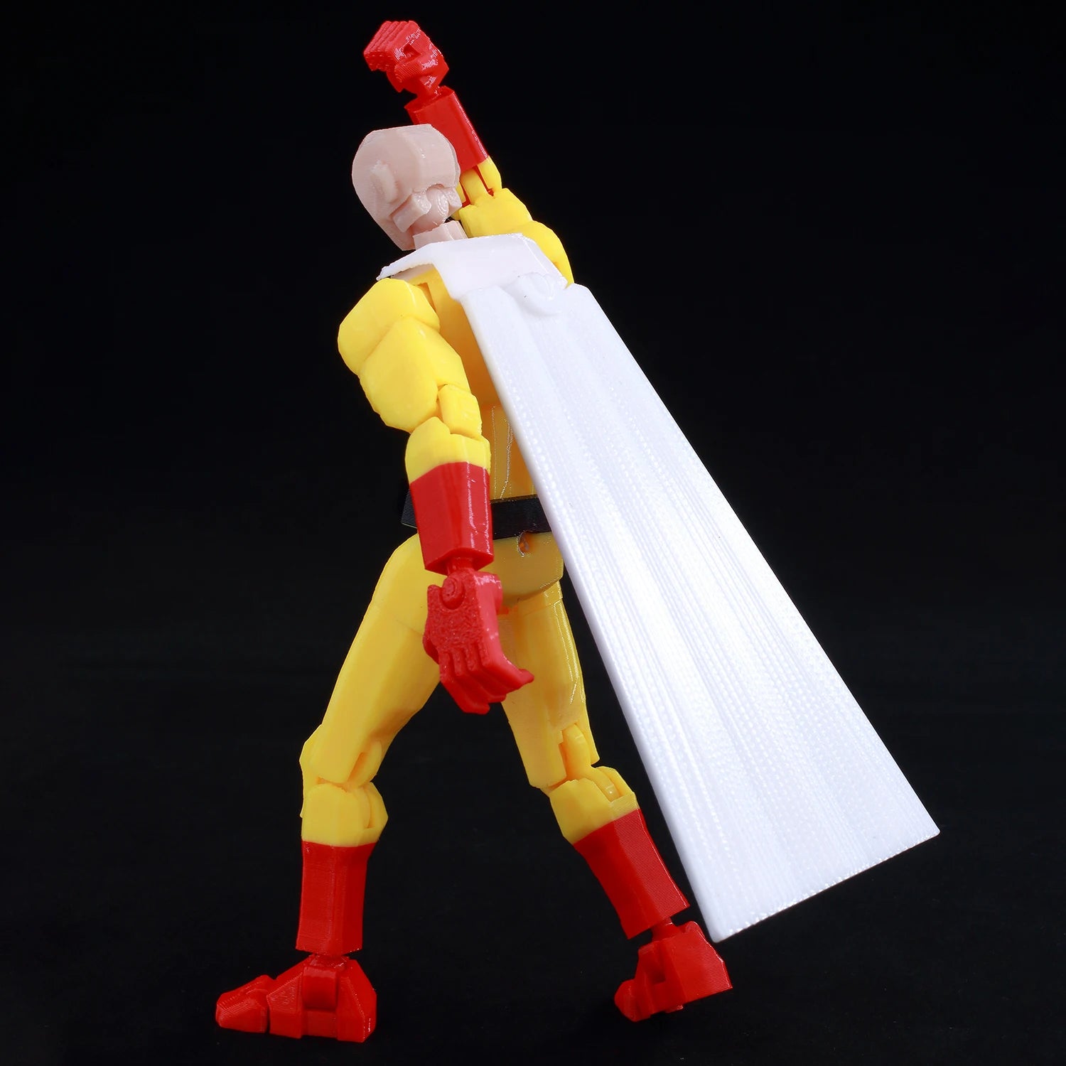 Action figure with yellow and red costume on a black background