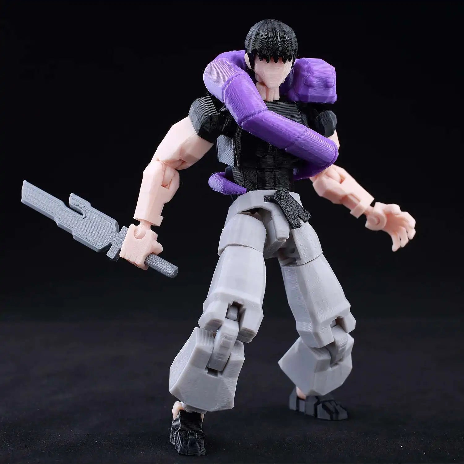 Action figure with purple arm gauntlets and gray legs on a black background