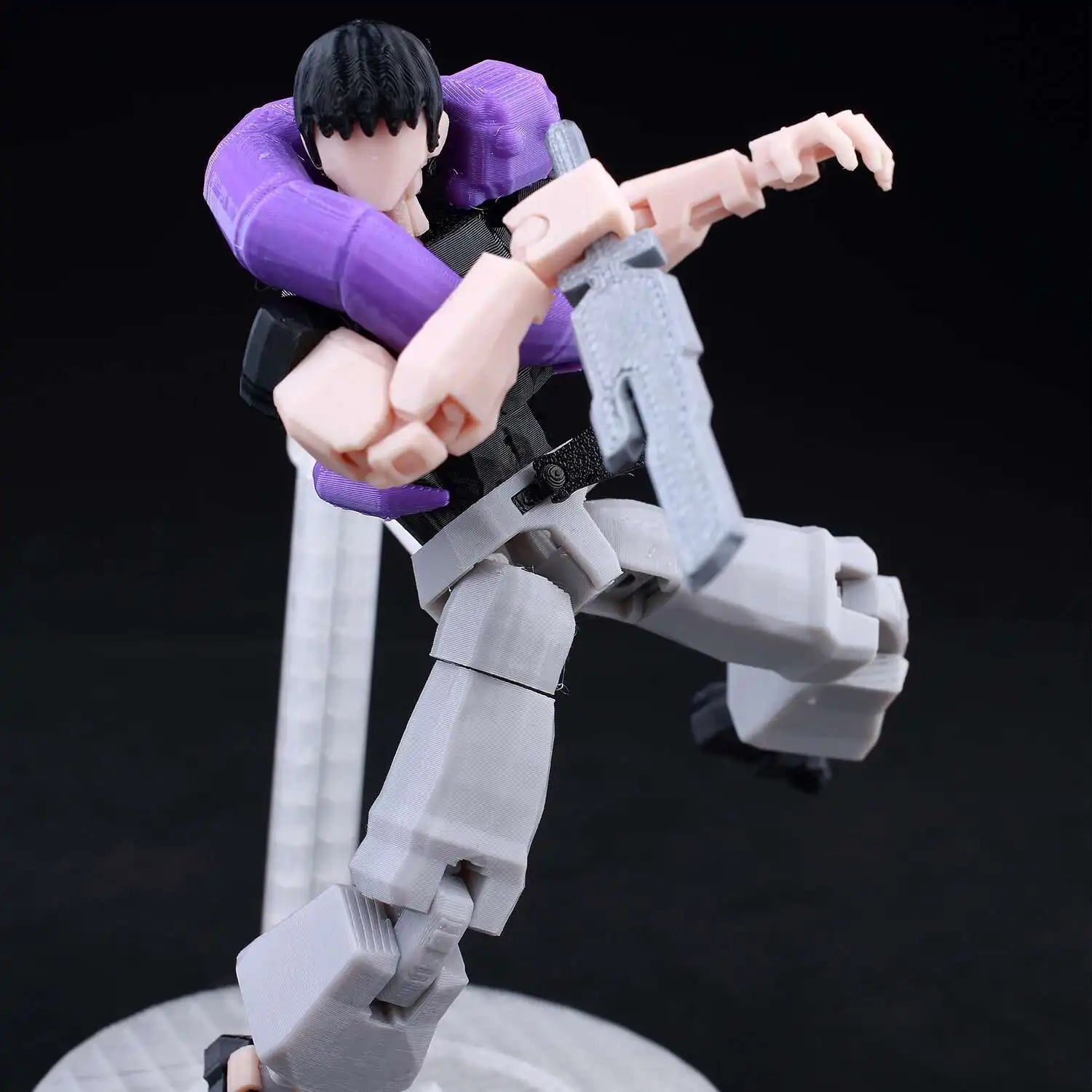 Action figure with purple and gray costume on a black background