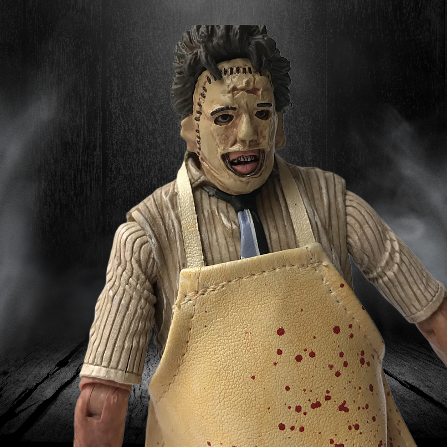 Action figure with a mask and apron on a dark background