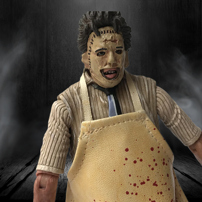 Action figure with a mask and apron on a dark background