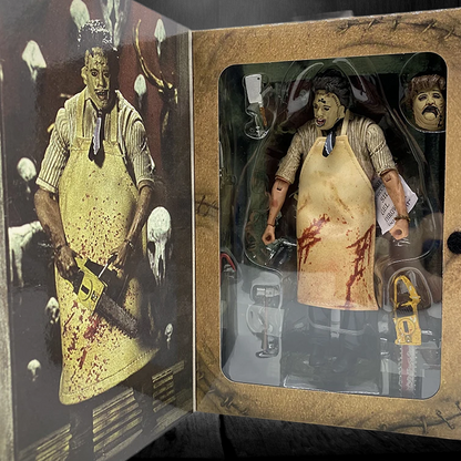 Action figure in a box with a bloody apron and weapon, surrounded by other action figures.