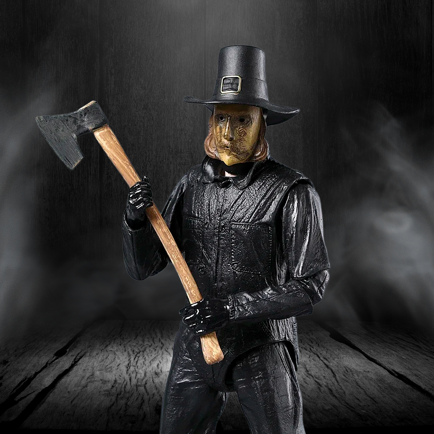Person in black leather outfit and mask holding an axe against a dark background