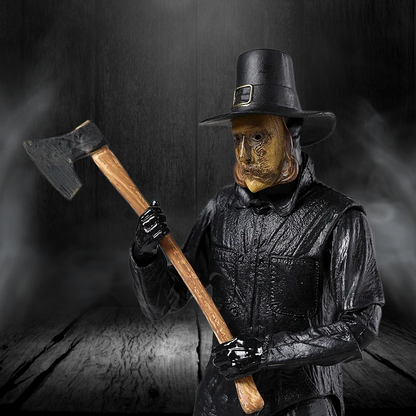 Person wearing a wooden mask and black outfit holding an axe against a dark background