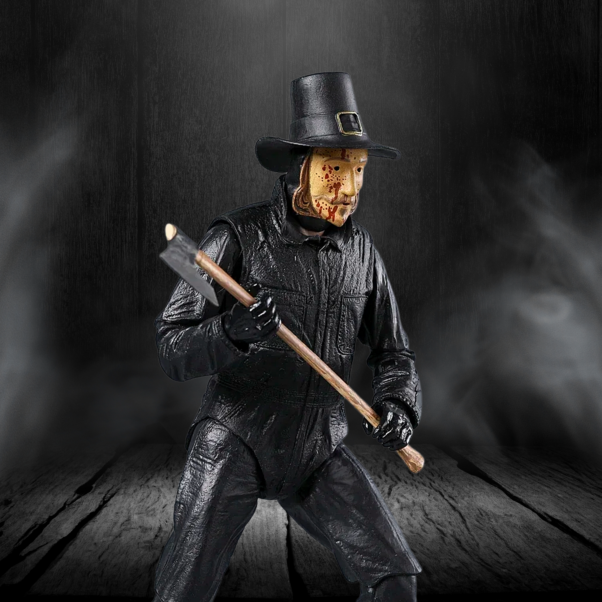 Action figure of a character in black attire with an axe against a dark background
