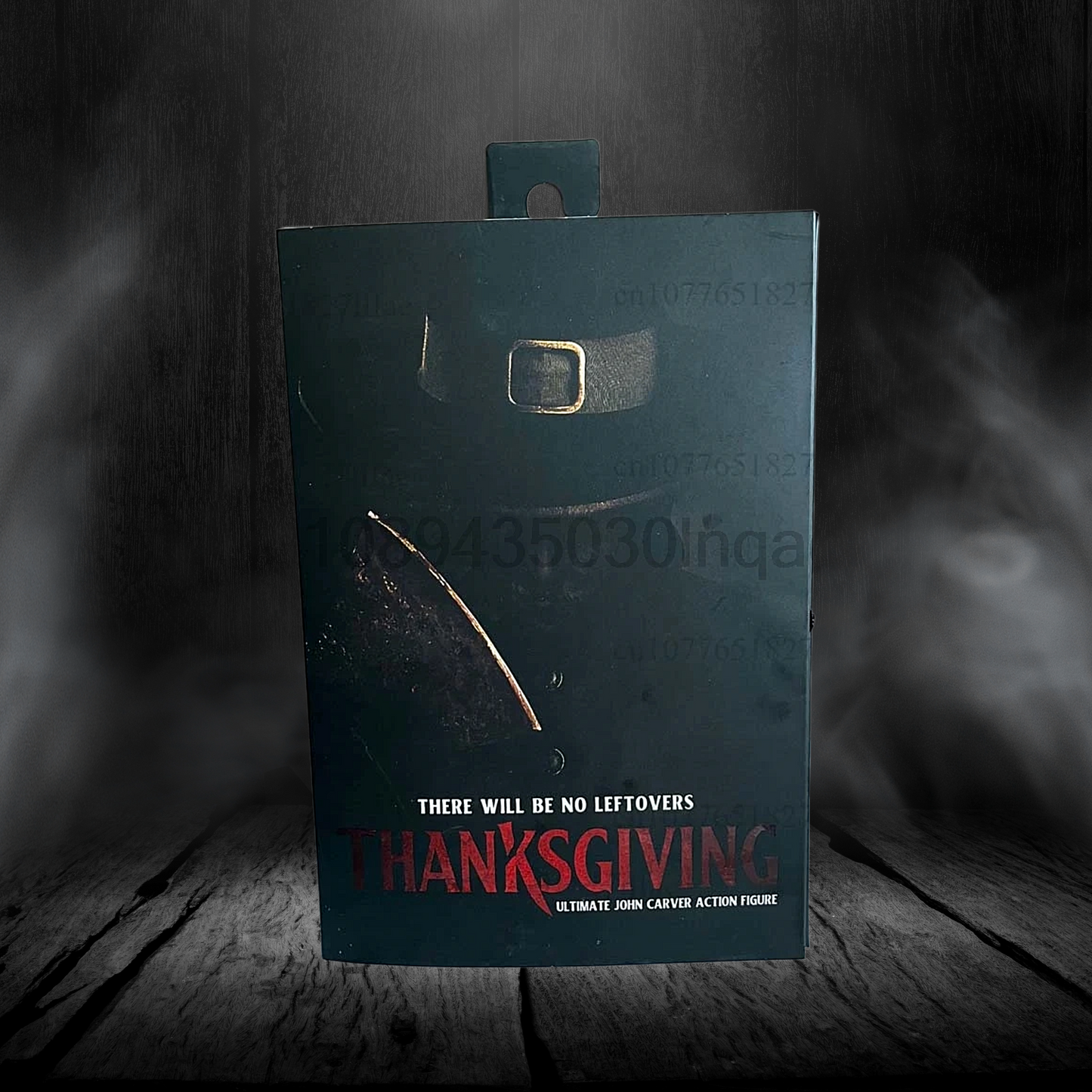 Dark blue box with text on a wooden surface and dark background